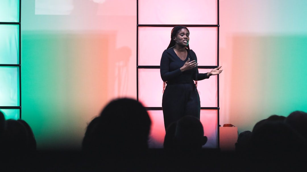 A speaker mid-story on a lit stage